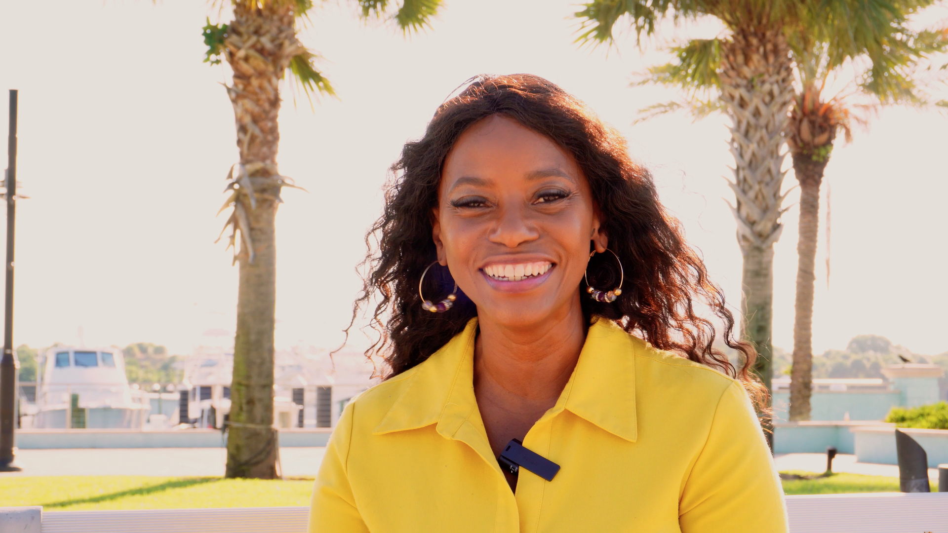 close up image of black woman in yellow dress